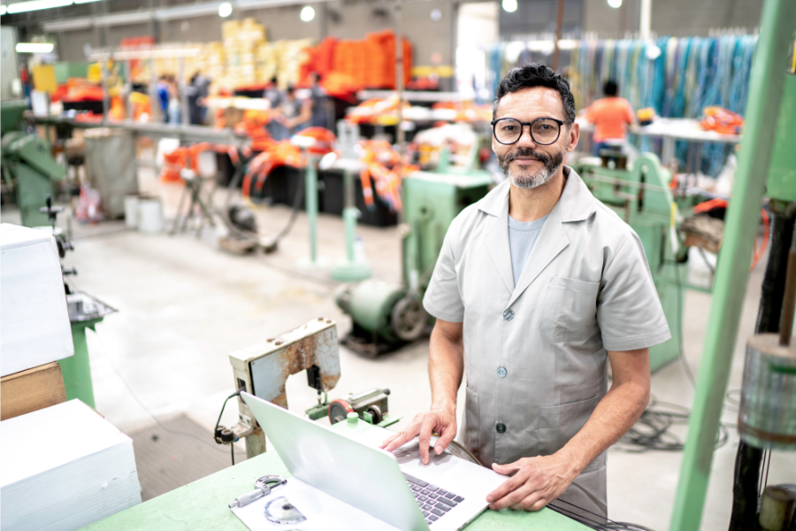Manufacturing employee reviewing digital training materials on a laptop during ESL training for manufacturing workers.