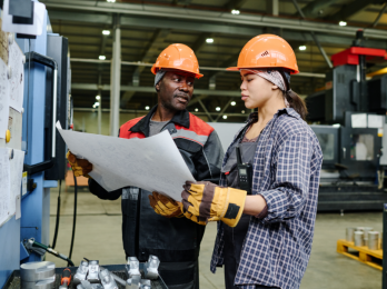 discussing plans at a manufacturing facility
