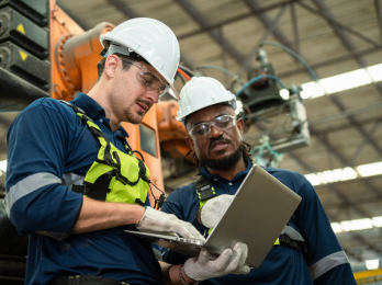 Immigrant workers looking at a production plan in California